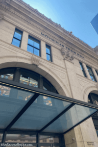 A spacious building with a prominent archway marks the entrance to Moynihan Train Hall in Midtown.