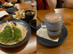 A table set with plates of Japanese food and a dessert in a mason jar at Raku in Midtown, New York.