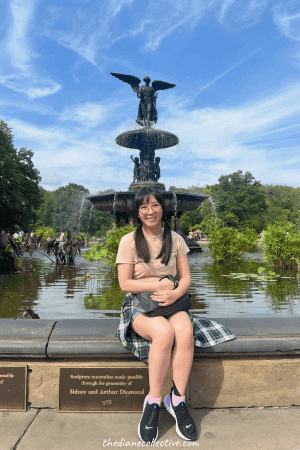 A girl sits on the edge of the fountain at Bethesda Terrace in Central Park