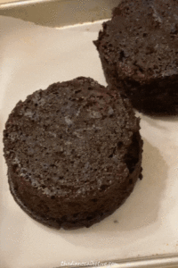 A baking sheet holds delicious mini chocolate cakes, showcasing their rich color and tempting appearance